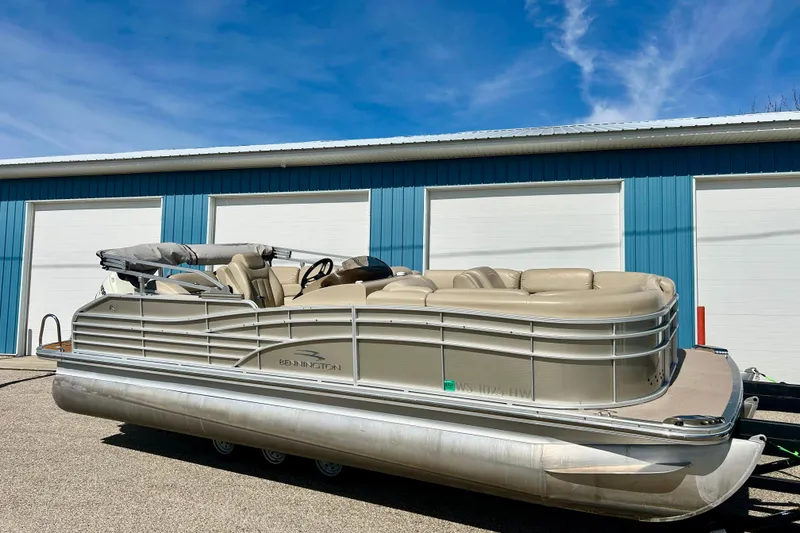 Slide: The Image of 2012 Bennington 2250RCL pontoon boat parked outside blue garage. - 50