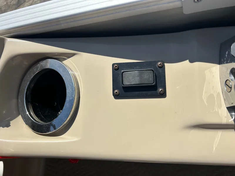 Slide: The Image of Evinrude E-TEC outboard motor on 2012 Bennington 2250RCL boat, docked outdoors. - 7