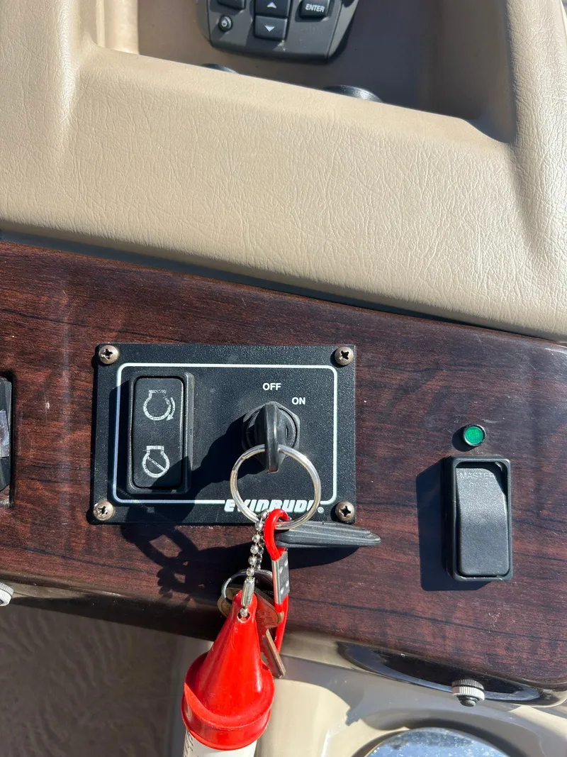 Slide: The Image of 2012 Bennington 2250RCL boat with Evinrude 250 outboard motor, docked on pavement. - 8