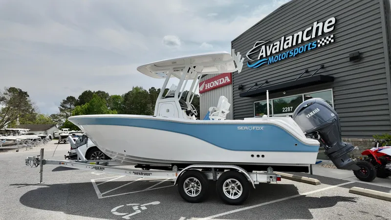 The Image of 2025 Sea Fox 228 Commander boat on trailer at Avalanche Motorsports dealership. - 1
