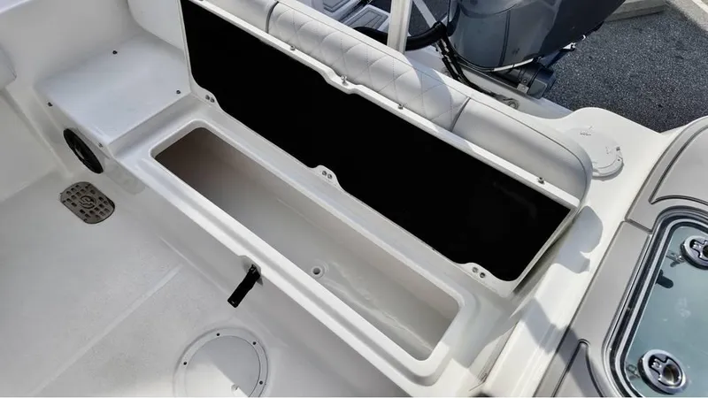 Slide: The Image of 2025 Sea Fox 228 Commander boat storage compartment, open and empty, with seating and deck visible. - 12