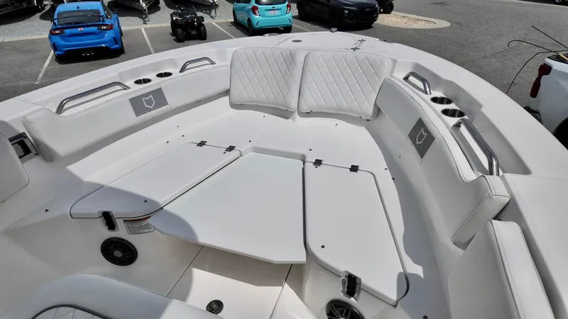 Slide: The Image of 2025 Sea Fox 228 Commander boat interior with white seating and storage compartments. - 4