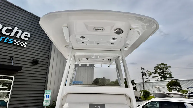 Slide: The Image of 2025 Sea Fox 228 Commander boat at dealership, showcasing T-top design. - 6