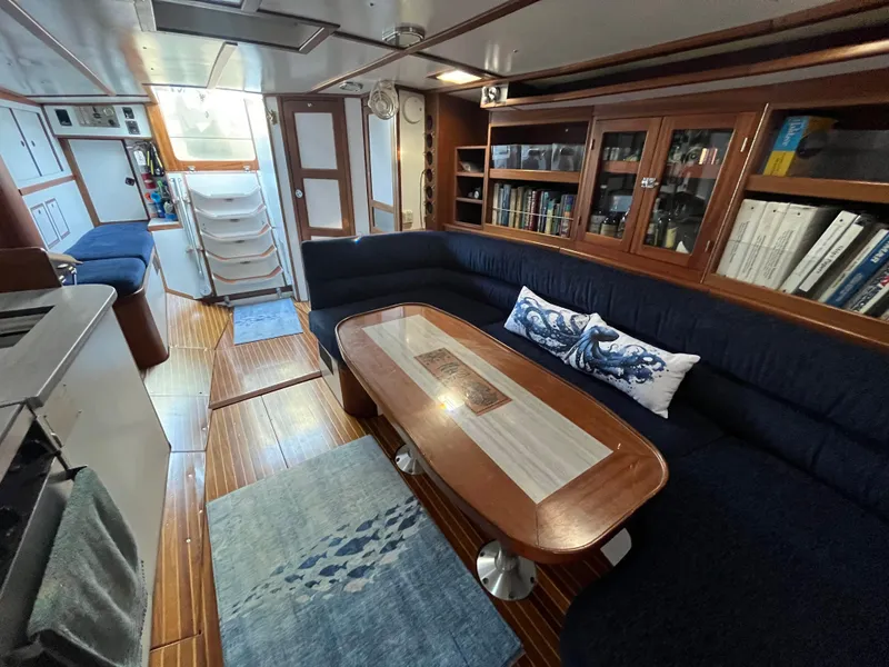 Slide: The Image of Luxurious 1976 Frers Custom yacht interior with elegant wood finishes and cozy seating area. - 16