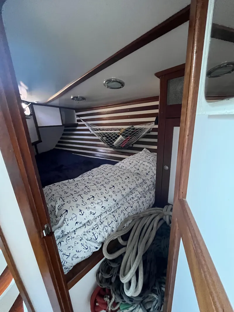 Slide: The Image of Cozy cabin interior of 1976 Frers Custom boat with nautical bedding and ropes. - 30