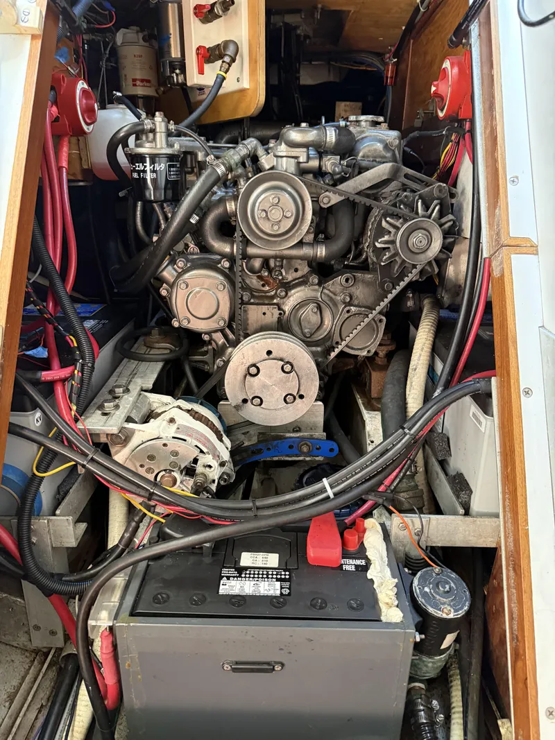 Slide: The Image of Engine compartment of a 1976 Frers Custom boat, showcasing mechanical components and wiring. - 31