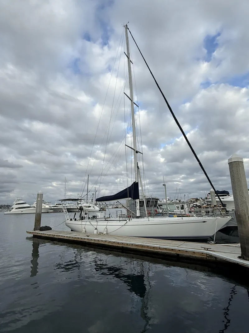 Slide: The Image of 1976 Frers Custom sailboat docked at marina under cloudy sky. - 5