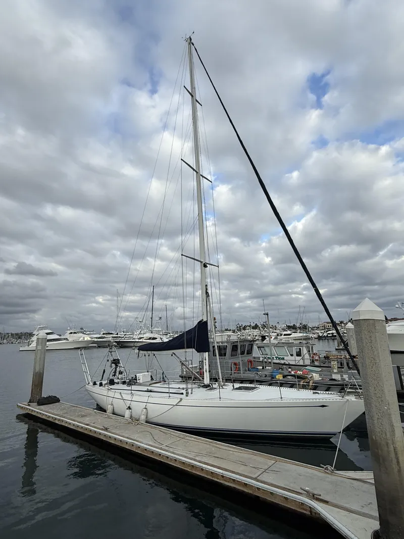 Slide: The Image of 1976 Frers Custom sailboat docked at marina under cloudy sky. - 6