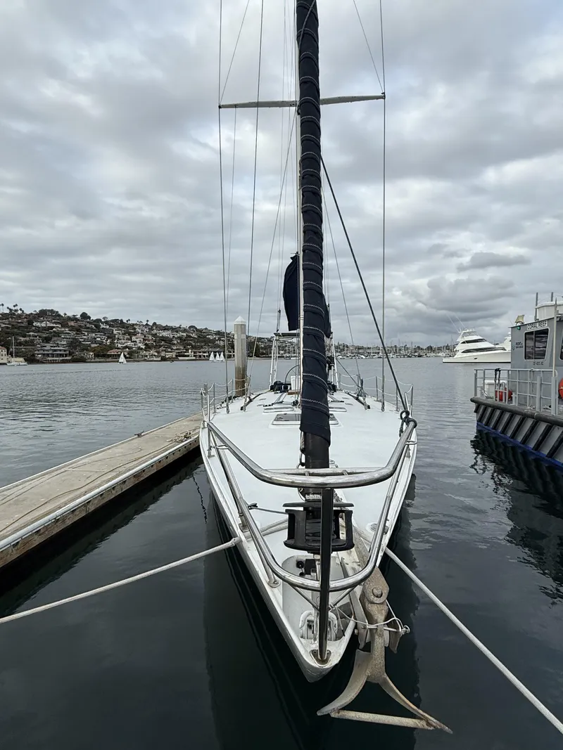 Slide: The Image of 1976 Frers Custom sailboat docked in a marina under cloudy skies. - 7