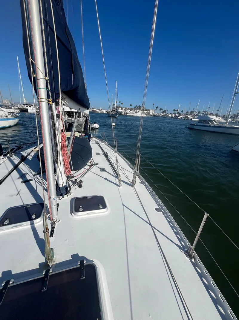 Slide: The Image of Sailboat deck view, Frers Custom 1976, in a marina under clear blue sky. - 8