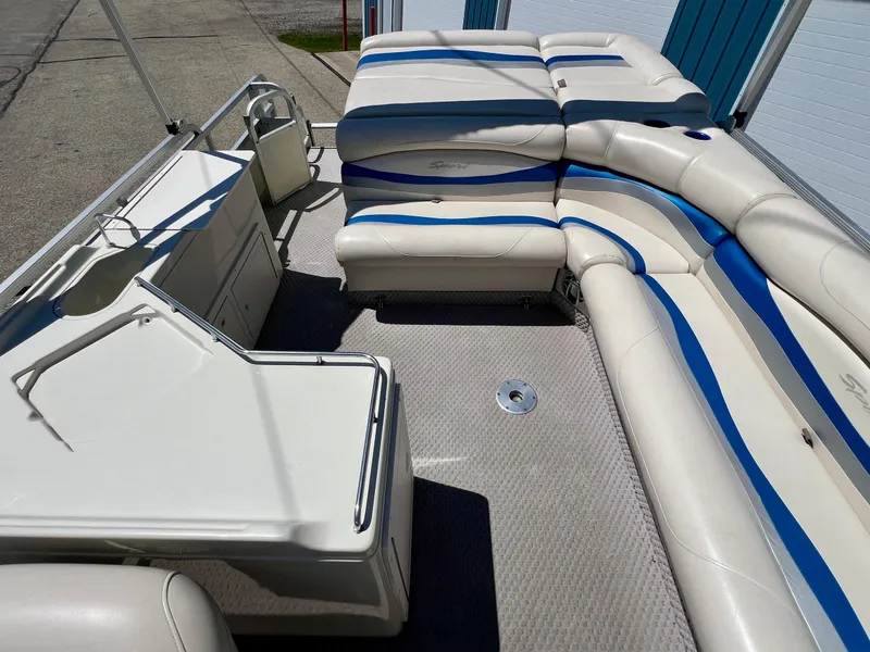 Slide: The Image of 2004 Bennington 2875RLX pontoon boat interior with white and blue seating. - 10