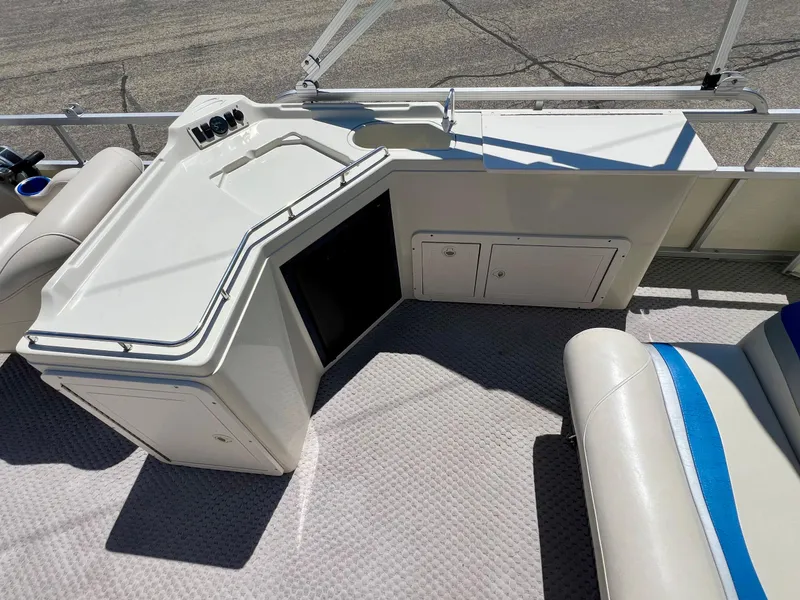 Slide: The Image of 2004 Bennington 2875RLX boat interior with seating and storage compartments. - 13