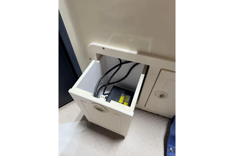 Slide: The Image of Open compartment with cables in a 2004 Bennington 2875RLX boat interior. - 24