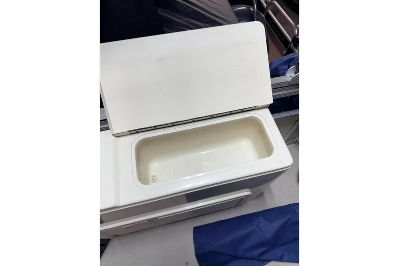 Slide: The Image of Open storage compartment on a 2004 Bennington 2875RLX boat, showcasing interior space. - 26