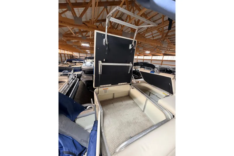 Slide: The Image of 2004 Bennington 2875RLX pontoon boat interior in storage facility. - 28