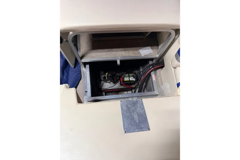 Slide: The Image of Open storage compartment in a 2004 Bennington 2875RLX boat, revealing wiring and battery. - 29