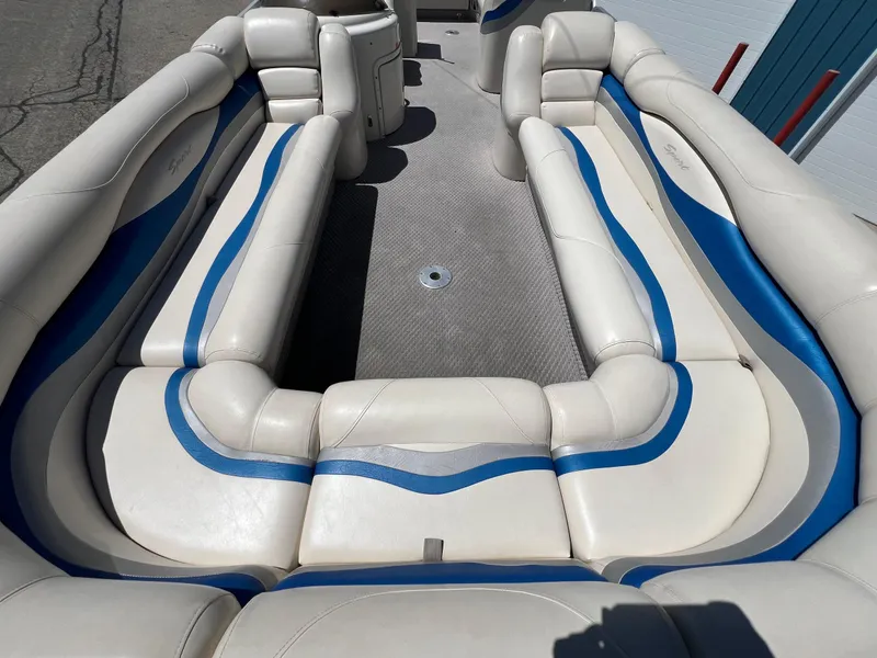Slide: The Image of 2004 Bennington 2875RLX boat interior with white and blue cushioned seating. - 3
