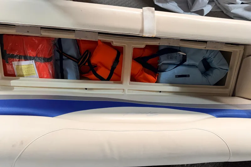 Slide: The Image of Storage compartment in a 2004 Bennington 2875RLX boat with life jackets and safety gear. - 35