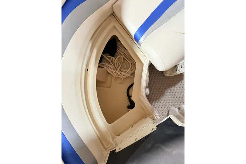 Slide: The Image of Storage compartment in a 2004 Bennington 2875RLX boat with rope and accessories. - 37