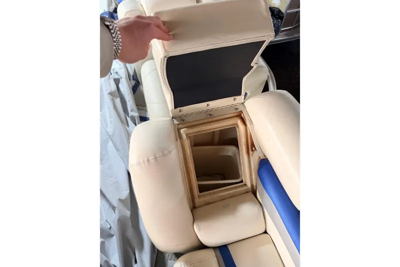 Slide: The Image of Open storage compartment in 2004 Bennington 2875RLX boat seat, showcasing interior space. - 38