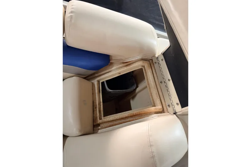 Slide: The Image of Open storage compartment in a 2004 Bennington 2875RLX boat with beige seating. - 39