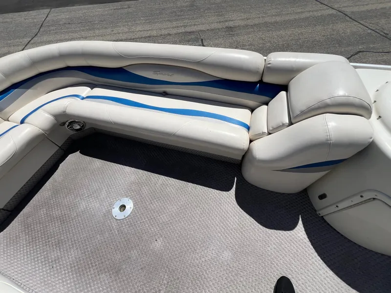 Slide: The Image of 2004 Bennington 2875RLX boat interior with white and blue cushioned seating. - 4