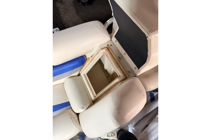 Slide: The Image of Open storage compartment in 2004 Bennington 2875RLX boat seat, showing interior details. - 40