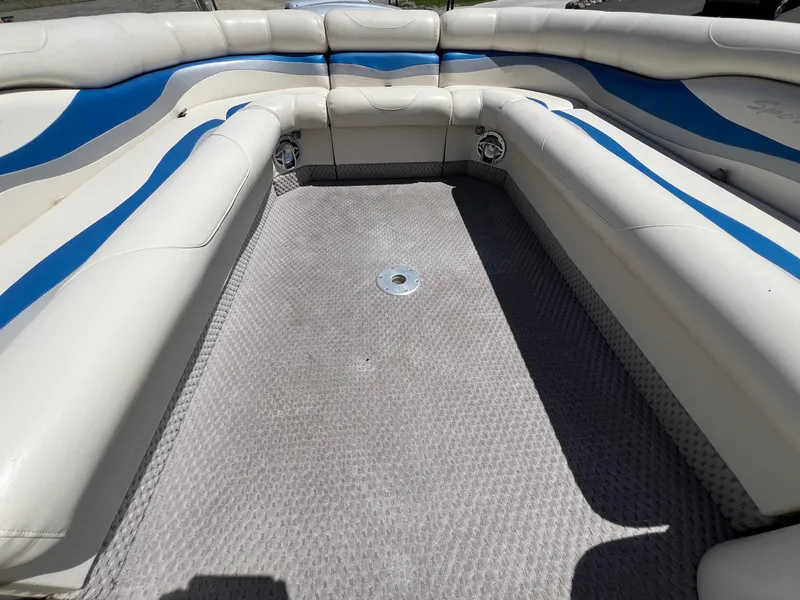 Slide: The Image of Interior of a 2004 Bennington 2875RLX boat with white and blue seating. - 5