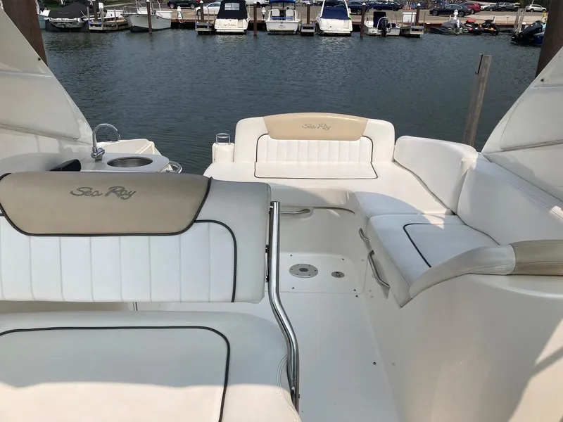 Slide: The Image of 2009 Sea Ray 270 Sundancer boat interior with white seating at marina. - 10