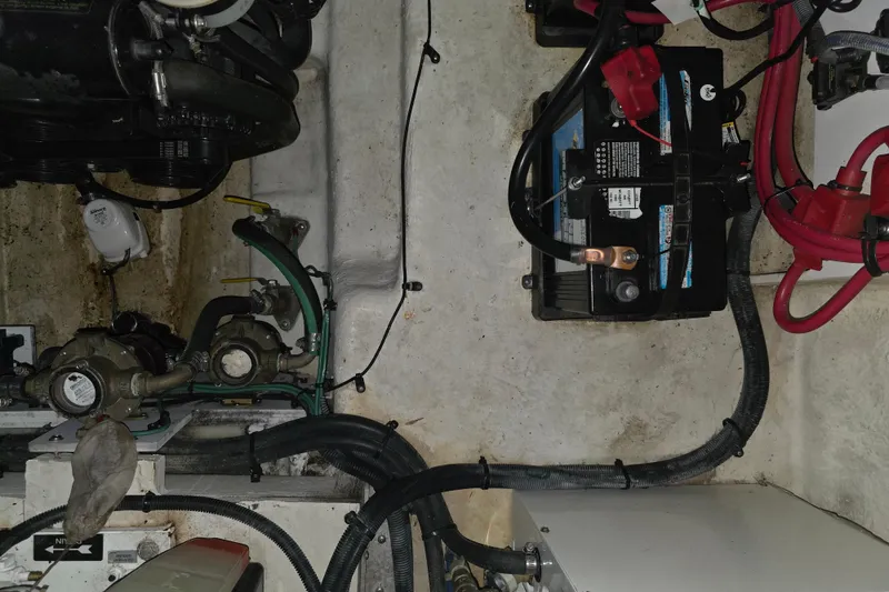 Slide: The Image of Engine compartment of a 2009 Sea Ray 270 Sundancer with battery and wiring. - 16