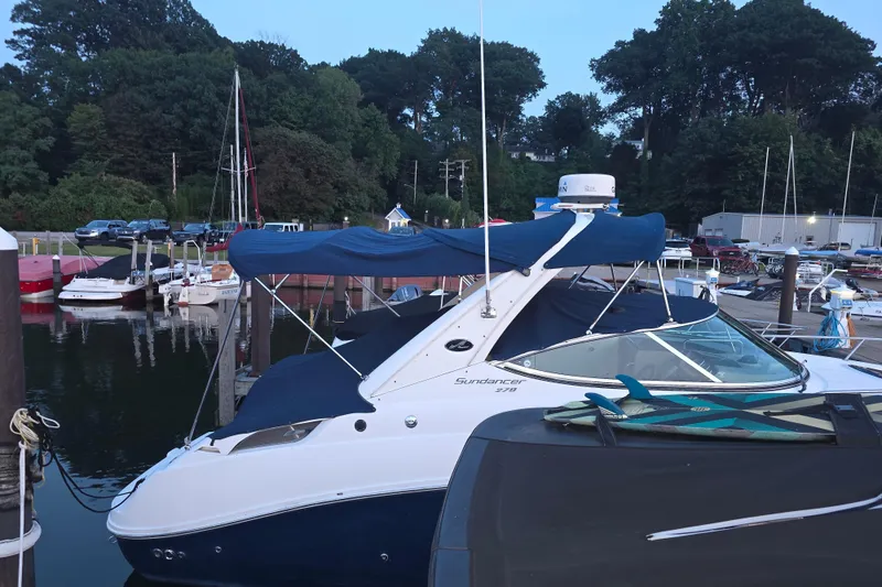 Slide: The Image of 2009 Sea Ray 270 Sundancer docked at marina with blue canopy. - 19