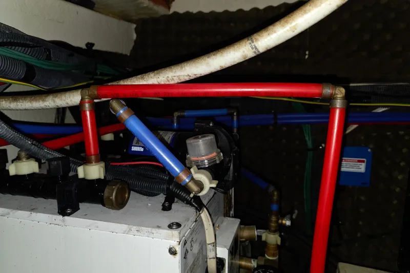 Slide: The Image of Engine room of 2009 Sea Ray 270 Sundancer with visible plumbing and wiring. - 23