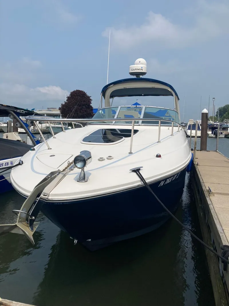 Slide: The Image of 2009 Sea Ray 270 Sundancer docked at marina, featuring sleek design and Garmin equipment. - 6