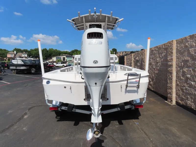 Slide: The Image of 2025 Savannah 220 IS boat, rear view, parked outdoors on a sunny day. - 3