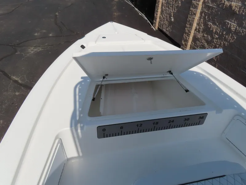Slide: The Image of 2025 Savannah 220 IS boat with open storage compartment and measurement scale. - 7