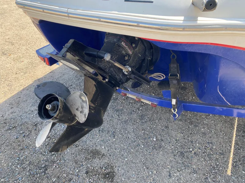 Slide: The Image of 2013 Tahoe Q5i boat stern with MerCruiser outdrive and propeller on gravel surface. - 11