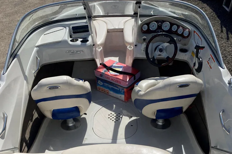 Slide: The Image of 2013 Tahoe Q5i boat interior with steering wheel, seats, and life jackets. - 14