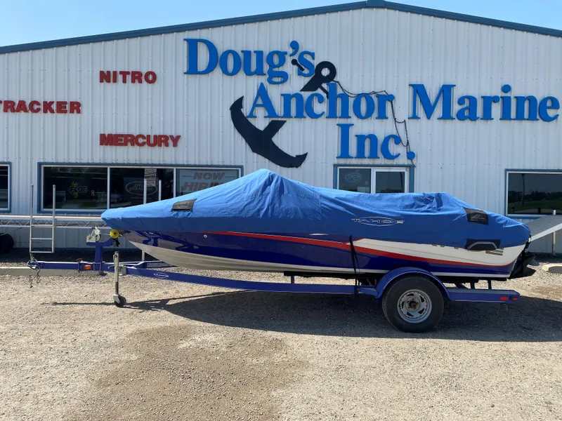 Slide: The Image of 2013 Tahoe Q5i boat covered, parked outside Doug's Anchor Marine Inc. - 2