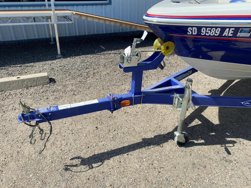 Slide: The Image of 2013 Tahoe Q5i boat on trailer with visible hitch and license plate. - 4