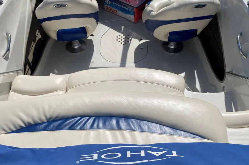 Slide: The Image of Interior of a 2013 Tahoe Q5i boat with blue and white seating. - 7