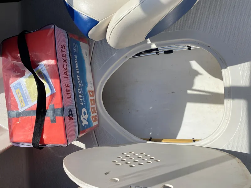 Slide: The Image of 2013 Tahoe Q5i boat interior with life jackets and storage compartment. - 8