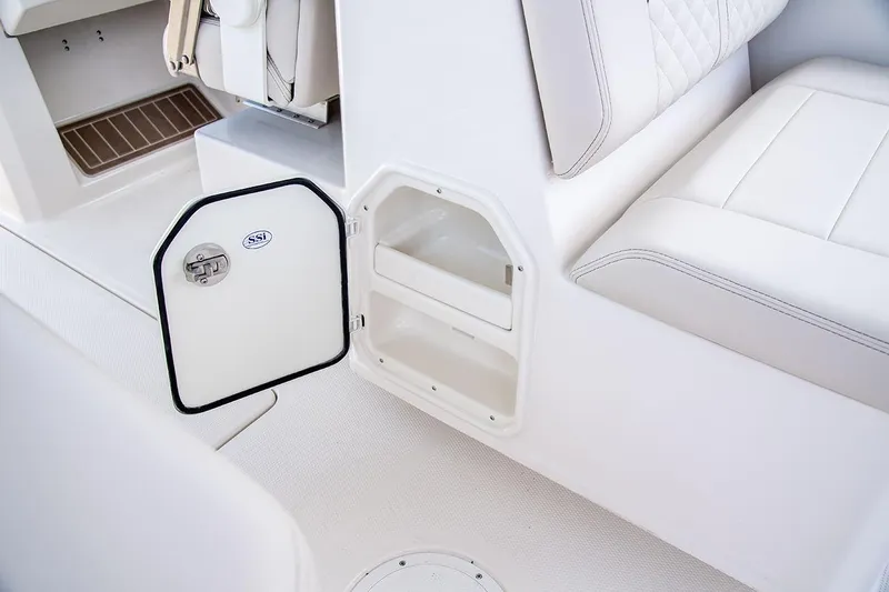 Slide: The Image of 2026 Sailfish 276 DC boat interior with open storage compartment and white seating. - 5