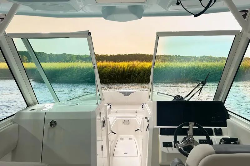 Slide: The Image of Interior view of 2026 Sailfish 276 DC boat with scenic water and grassland backdrop. - 7