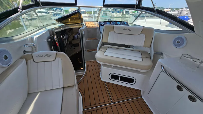 Slide: The Image of 2013 Sea Ray 280 Sundancer interior with white seating and wood flooring. - 11