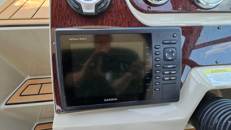 Slide: The Image of Garmin GPSmap 840xs on 2013 Sea Ray 280 Sundancer dashboard, featuring wood paneling. - 16