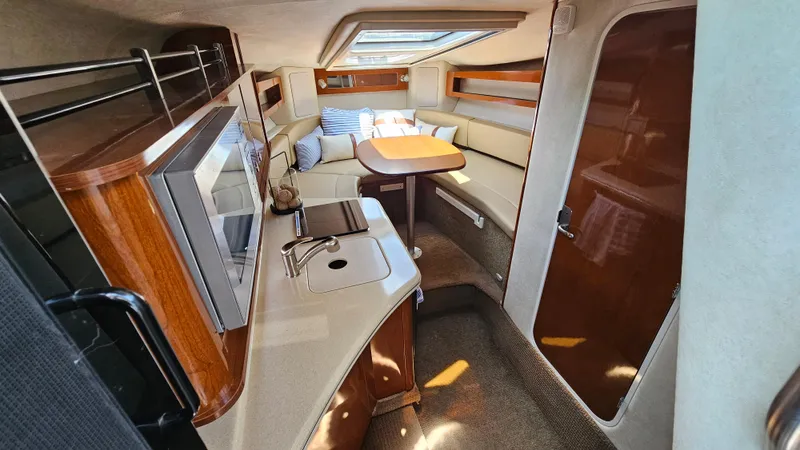 Slide: The Image of Interior of 2013 Sea Ray 280 Sundancer yacht with kitchenette and seating area. - 18