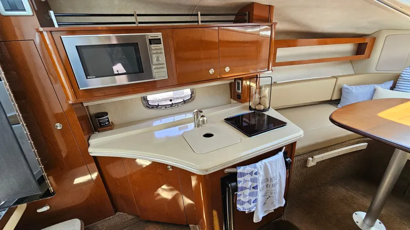 Slide: The Image of Luxurious 2013 Sea Ray 280 Sundancer cabin with kitchenette and seating area. - 20