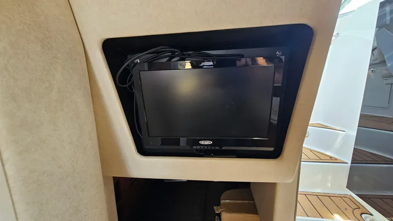Slide: The Image of Built-in TV on 2013 Sea Ray 280 Sundancer yacht interior. - 23