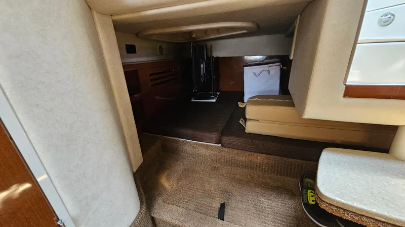 Slide: The Image of Interior cabin of 2013 Sea Ray 280 Sundancer with beige and brown furnishings. - 24