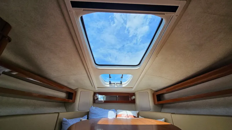 Slide: The Image of Interior view of 2013 Sea Ray 280 Sundancer cabin with skylight and cushions. - 26